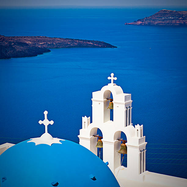 istock Famous Orthodox church with blue dome on Santorini 185255888
