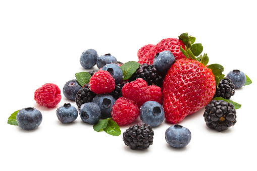 Mix of differrerent berries with leaves. Isolated on white.