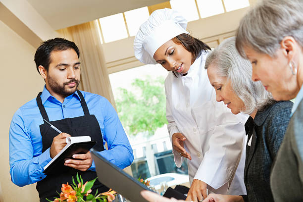 istock Chef and waiter helping customers in restaurant order 185256139