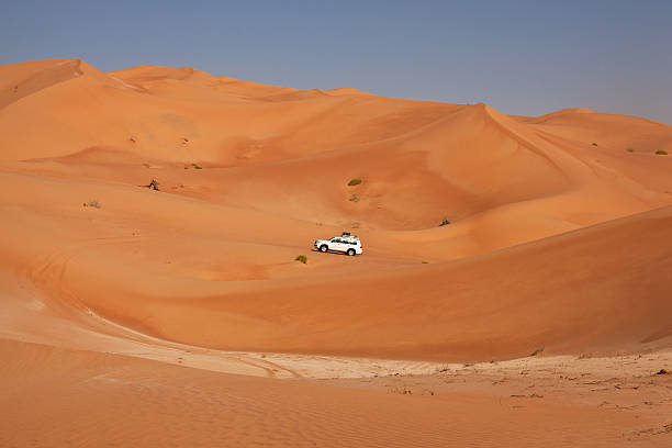 istock Car driving in the desert between sand dunes 185256342