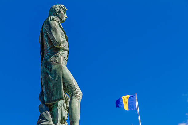 Lord Nelson Statue "Lord Nelson Statue with Barbadian flag waving. The bronze statue of Admiral Lord Nelson was erected on 1813 and placed in the big square opposite the Parliament Buildings, once called Trafalgar Square. In 1999 the square was renamed and dedicated to the national heroes of Barbados, and the statue was moved on the west side of the square, where it still stands." admiral nelson stock pictures, royalty-free photos & images