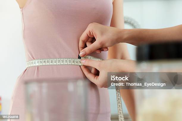 Woman Measuring Friends Waist Stock Photo - Download Image Now - 25-29 Years, Achievement, Adult