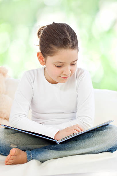 istock Beautiful little girl reading 185257135