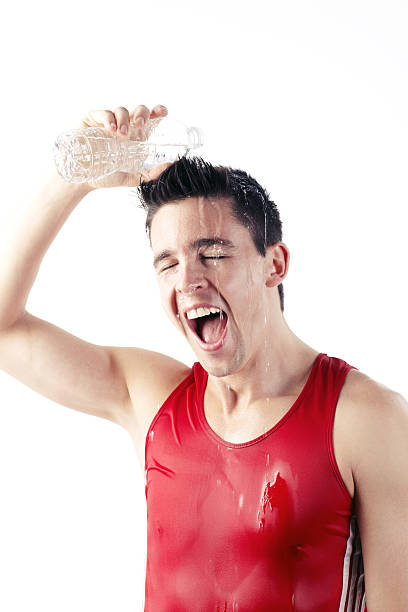 istock Athlete pouring water and smiling after training 185257150