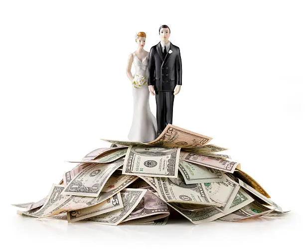 Heap of money with wedding cake topper.