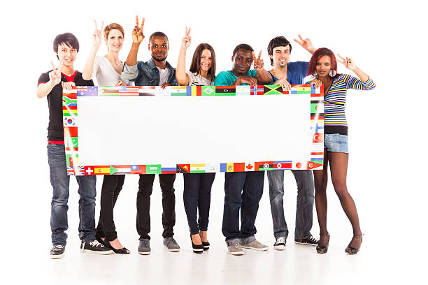 multi-ethnic group of young adults multi-ethnic group of young adults. image shows public-domain flags from the CIA world factbook. apartheid sign stock pictures, royalty-free photos & images