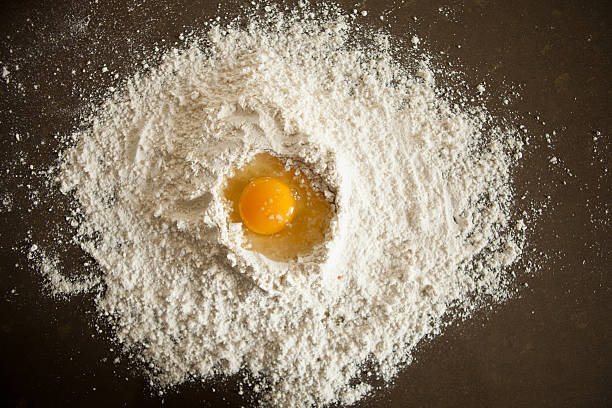 istock Egg in the center of flour 185257620