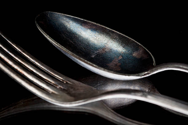 istock Close-up of old tarnished silver spoon and fork 185257751