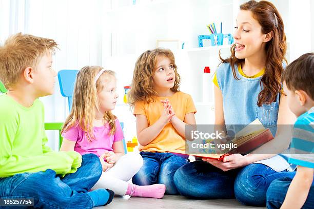 Teacher Telling A Story To Children Stock Photo - Download Image Now - Storytelling, Child, Fairy Tale