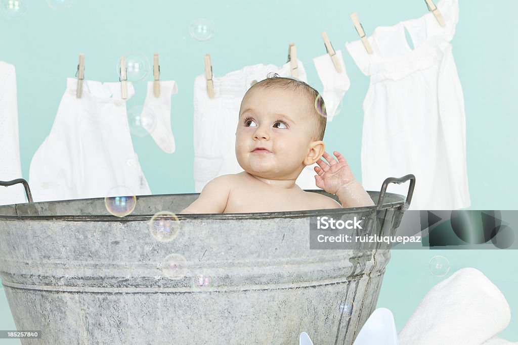 Having fun at bath Cute 6 months old little baby enjoying his bath Baby - Human Age Stock Photo