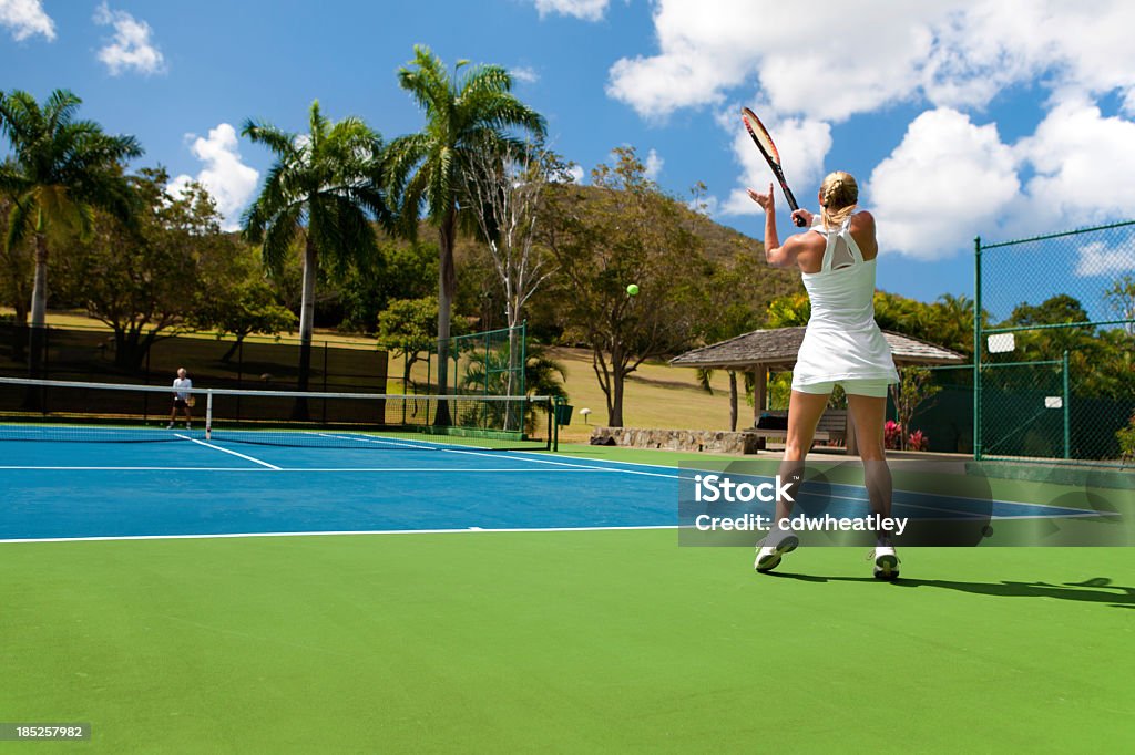 Duas pessoas para jogar tênis em um ambiente tropical - Foto de stock de Brincar royalty-free