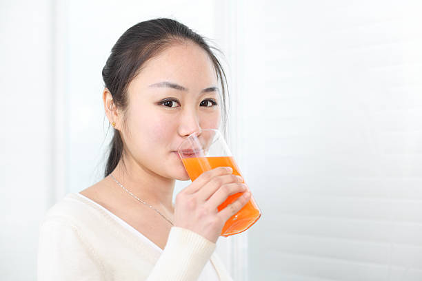 istock woman is drinking juice 185258067