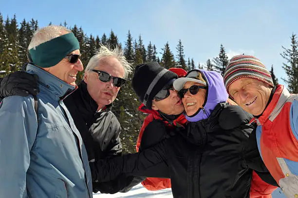 There are more of these. The men had fun with the lady during a ski rest.