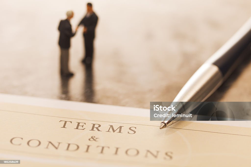 Terms and conditions "Document entitled Terms and Conditions, a pen and two defocused businessmen making a deal. ++Note: Document title designed by me++" Terms And Conditions Stock Photo
