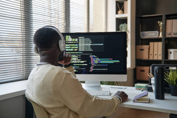 Software Developer Fixing Bugs Pensive software developer searching way to fix bugs in programming code debug stock pictures, royalty-free photos & images