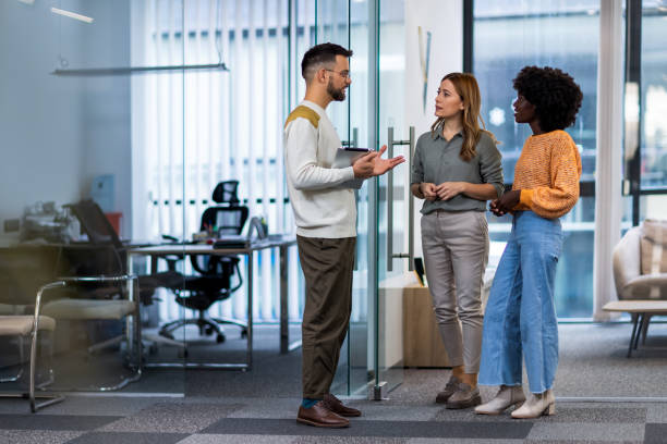 istock International workers group and team leader having teamwork discussion managing project at work in meeting room. 1852596289