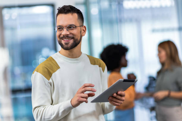 istock Business man standing in his office with his tablet. 1852596858