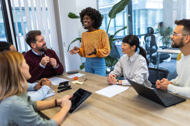 istock International workers group and team leader having teamwork discussion managing project at work in meeting room. 1852599115