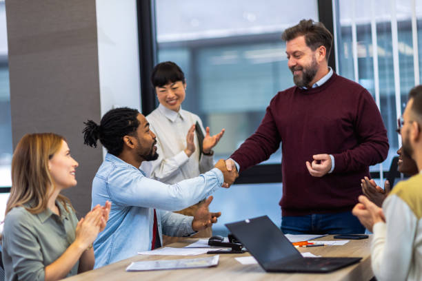 istock International workers group and team leader having teamwork discussion managing project at work in meeting room. 1852599673