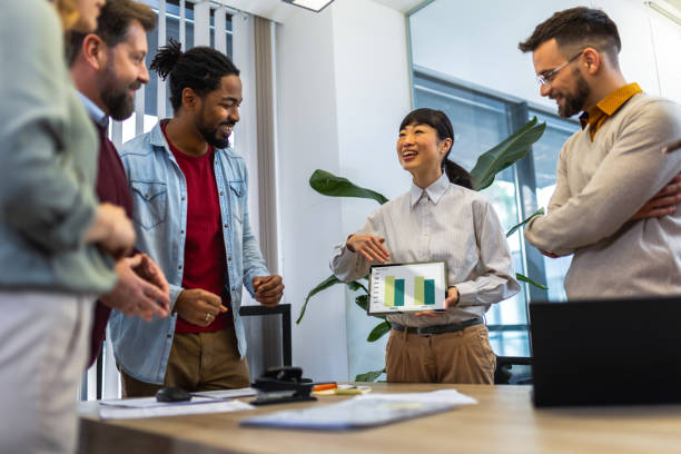 istock Multiethnic colleagues standing together and talking about work in their modern office. 1852600211