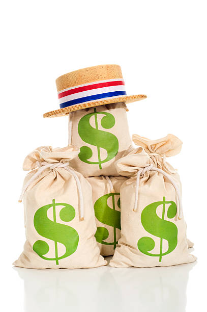 Political Fund raising Political fund raising / contributions. A Patriotic skimmer hat sits atop a pile of money bags on a white background with a reflection rnc convention stock pictures, royalty-free photos & images