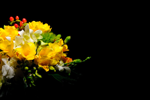 A macro image of the flower of a yellow-red rose.