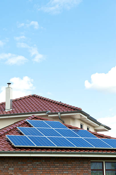 istock Solar panels on red roof a nice day 185260441