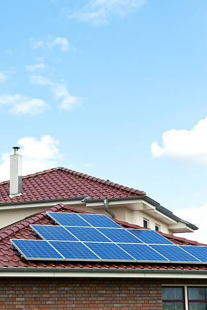 Solar panels on red roof a nice day stock photo