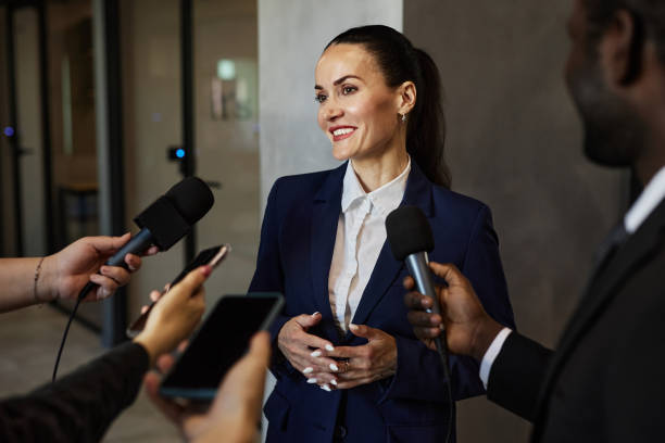 istock Smiling Company Representative Giving Opinion to Journalists 1852606970
