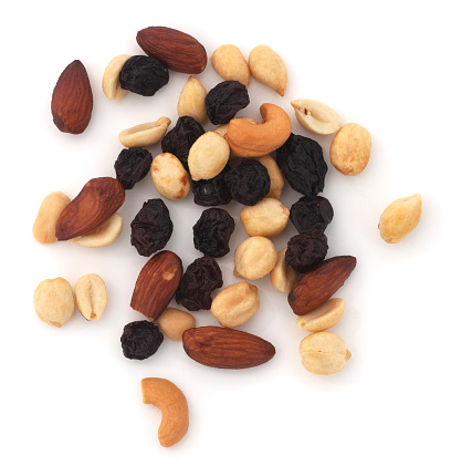 Isolated mixed nuts and raisins on a white background.