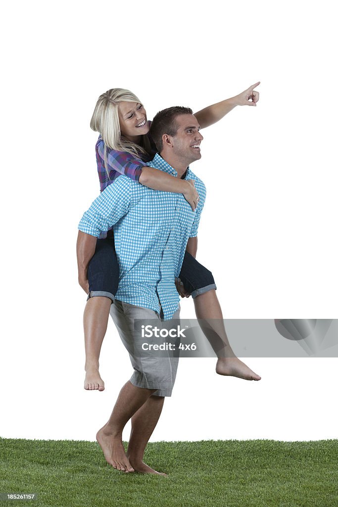 Woman riding piggyback on a man's shoulders Piggyback Stock Photo