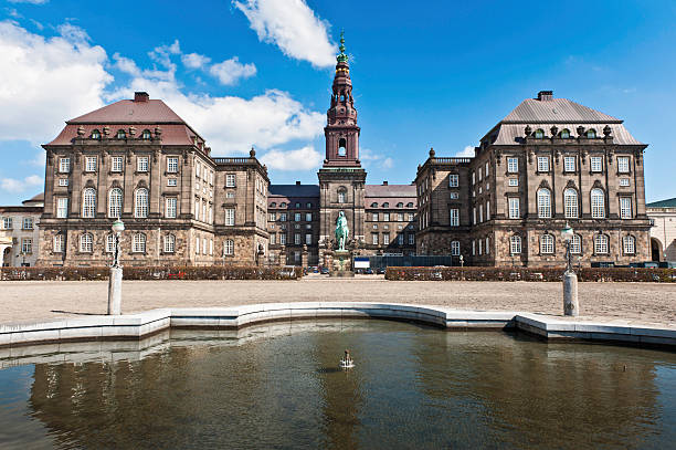 Copenhagen Folketing Parliament Christiansborg Palace "The Riding Ground Complex and fountain in the central courtyard of Christiansborg Palace, the historic castle on Slotsholmen, home of the Folketing - Danish parliament - the Prime Minister's Office and Danish Supreme Court under blue spring skies in the heart of Copenhagen, Denmark. ProPhoto RGB profile for maximum color fidelity and gamut." danish culture stock pictures, royalty-free photos & images