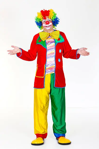 Funny clown standing with hands outstretched.