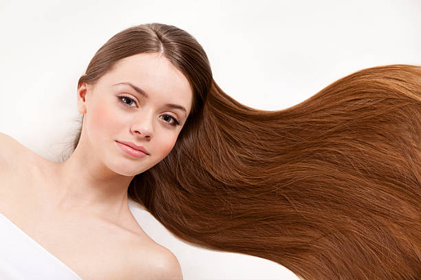 Beautiful blonde woman girl with long blond hair smooth and beauty in silver wear. Studio shot.