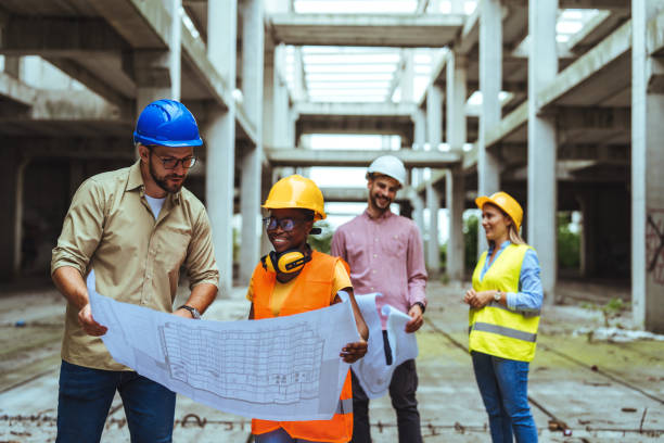 istock Team of construction workers discussing project details with executive supervisor 1852618033