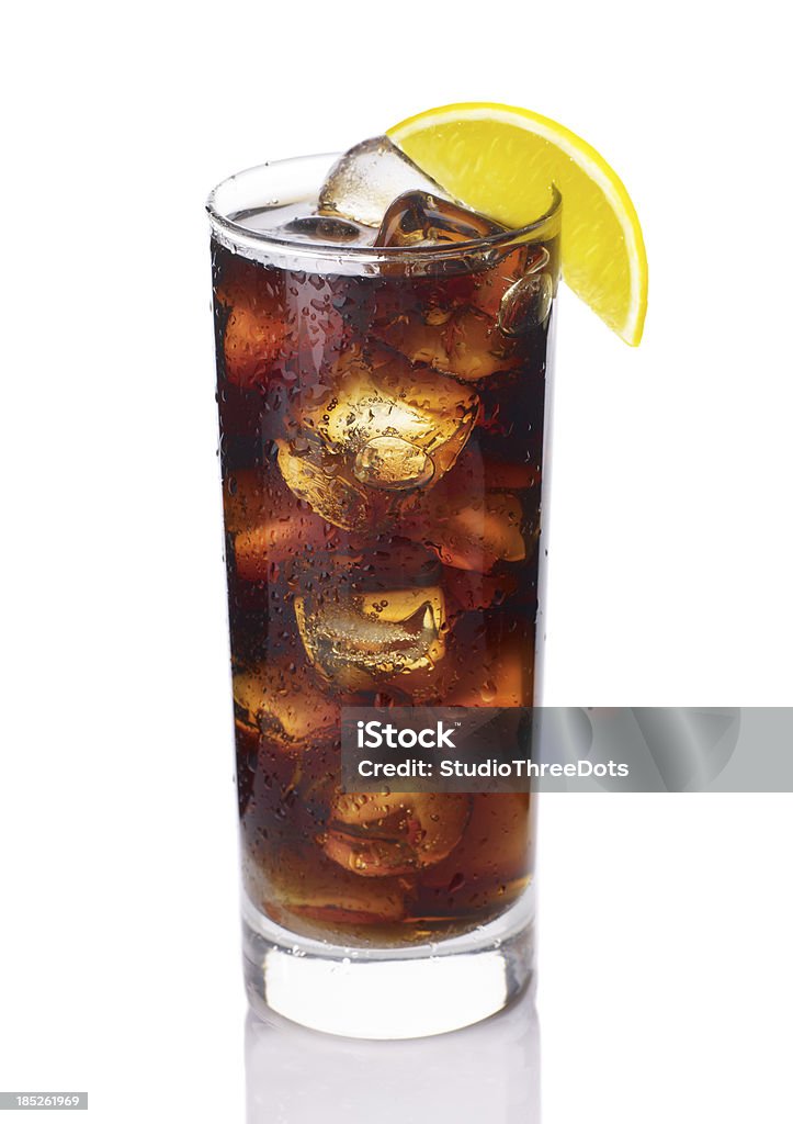 glass of cola with ice glass of cola with ice and lemon garnish isolated on white background. Cola Stock Photo