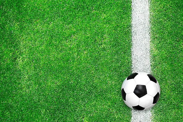Soccer ball on green grass. Top view.