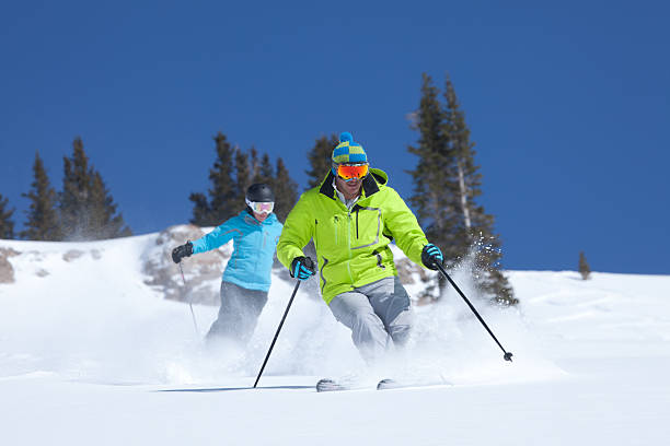 Couple skiing in fresh Powder snow, Colorado,USA stock photo