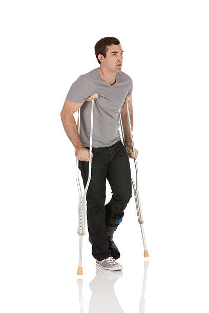 istock Injured man walking with the help of crutches 185262918