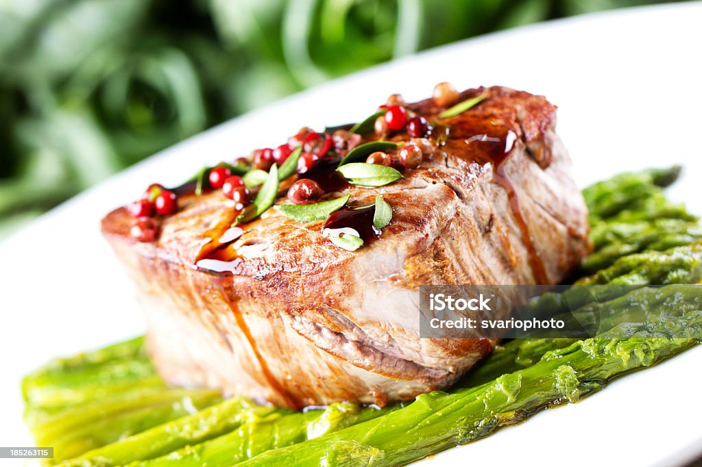 Filetto di manzo con pepe rosa e asparagi - Foto stock royalty-free di Asparago