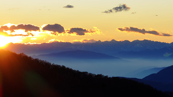 Sun sets over glaciated mountains and ranges