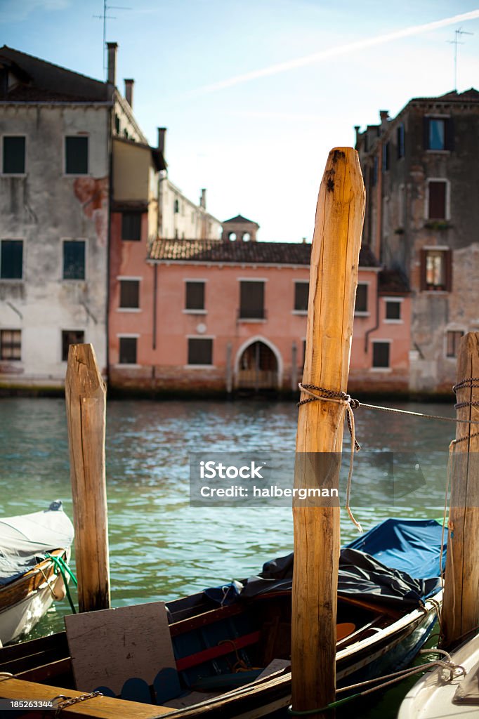 Docked Boat, Venice, Italy A boat docked to a pier in Venice, ItalyThe marble and plaster entrance hall of a centuries-old Venetian building Canal Stock Photo