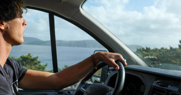 istock Young man drives car along the seaside 1852633480