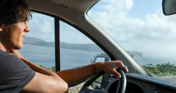 istock Young man drives car along the seaside 1852633481