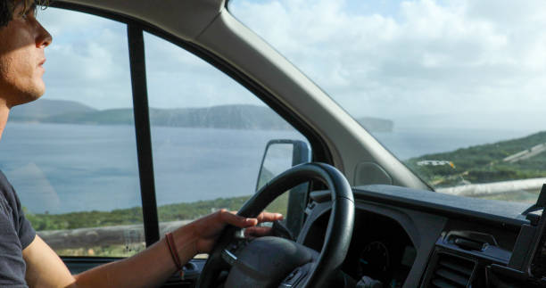 istock Young man drives car along the seaside 1852634526