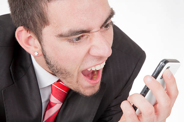 istock Young businessman shouting on the phone 185263952