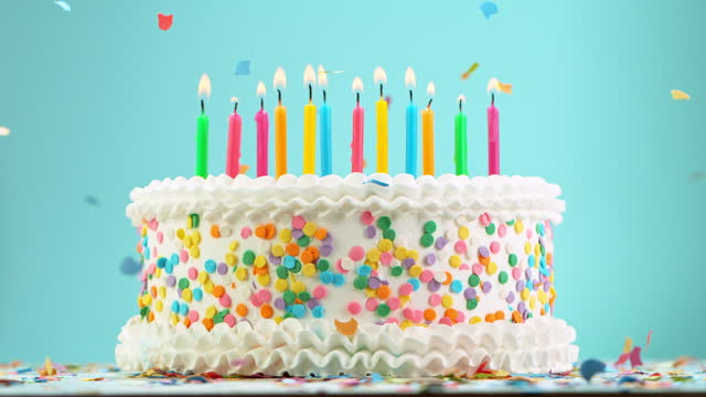 Birthday Cake with Burning Candles on Pastel Blue Background
