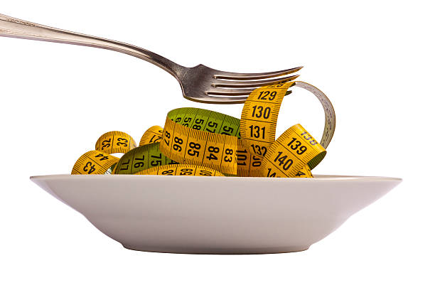 de dieta - healthy eating fork tape measure still life - fotografias e filmes do acervo