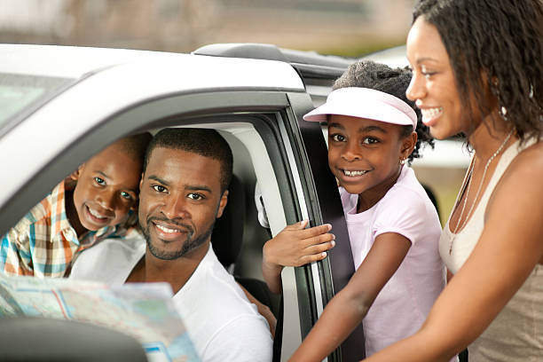 Family Vacation A happy family with their minivan. family-van-driving stock pictures, royalty-free photos & images