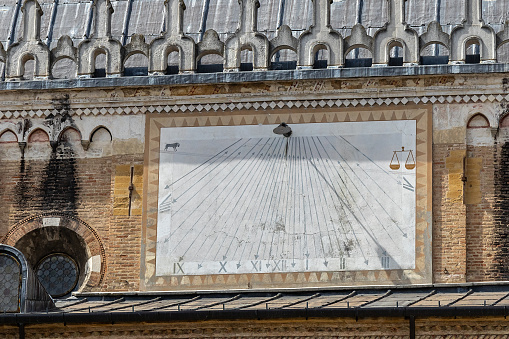 Sundial Clock on the facade of the medieval building Palazzo della Ragione in Padua city center; Veneto, Italy